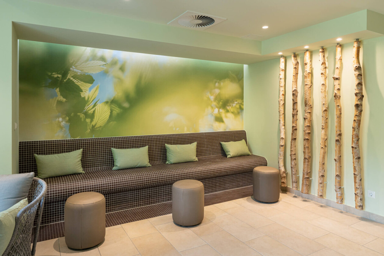 Eine beheizte Bank vor einer Wand aus Birken